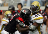 Jackets DE Michael Johnson fights off the block of GWU RB Philip Peoples