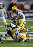 Yellow Jackets DT Elris Anyaibe fights through a block by LSU OG Lyle Hitt to get to RB Williams