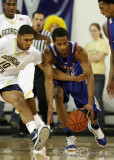 Georgia Tech G Lance Storrs attempts to steal the ball from Tigers F Cox