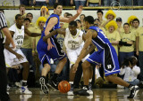 Yellow Jackets F Lawal fights off a screen by Duke C Zoubek to stay with G Henderson