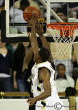 Yellow Jackets F Aminu blocks the layup of Demon Deacons G L. D. Williams