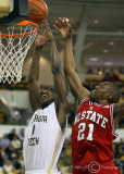 Yellow Jackets G Iman Shumpert goes up for the basket with Wolfpack G C.J. Williams defending
