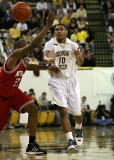 Georgia Tech G Lance Storrs delivers a pass over the outstretched arm of N.C. State G Williams