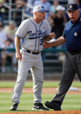 North Carolina Tar Heels Head Coach Mike Fox is escorted off the field by an umpire after being ejected in the 11th inning