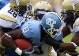 Yellow Jackets defenders surround North Carolina WR Greg Little after a catch