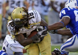 Yellow Jackets B-back Allen holds on to the ball as he goes by Blue Devils DE Kenny Anunike