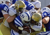 Yellow Jackets defenders corral a Blue Devils running back