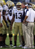 Georgia Tech Yellow Jackets Head Coach Paul Johnson huddles with his offense during a timeout