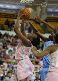 GT F Mitchell is fouled by UNC F Pringle while driving in for the lay-up