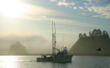 Fishing boat returning at sunset