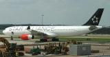 Ignoring the construction machinery along its way, this SAS 330 taxis to its stand at IAD, Aug, 2004