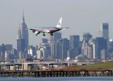 Ex-TWA 757 in AA color landing on LGA RWY 22, with NY skyline as the background