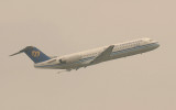 Mandarian Air Fokker-100 taking off from Song Shan Airport, Taipei