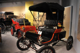 1901 Oldsmobile Curved Dash, foreground, and 1903 Ford Model A Runabout.