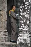 Security guards are there to keep visitors from climbing onto restricted areas. This young lady looks totally bored.