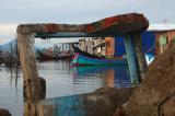 New boats seen behind old damaged structures