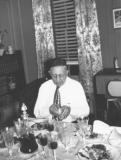 Grandpa Charles (father's side) opening his prayer book. Passover seder at grandparents' apartment in the Bronx (1949)
