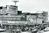 Nathans at Coney Island - famous for its hot dogs. The Parachute Jump  & the Wonder Wheel rides are in the background. (1950s)