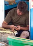 Fisherman at  Agia Marina baiting hooks