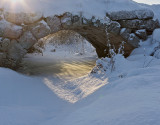 The old stone bridge in a bleak winter sun