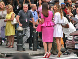 Two well-dressed ladies crossing 5th Avenue
