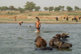 Young Boy with Wallowing Water Buffalo