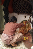Woman Annointing Ganesha Shrine Kathmandu