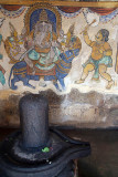 Stone Lingam with Painted Wall behind