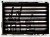 harbour cranes reflected on window shades