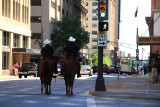 TWO COPS, TWO HORSES, TWO COWBOY HATS WALKING DOWNTOWN FORT WORTH