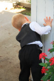 RING BEARER PEEKING AROUND THE CORNER