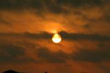 SUN RISING BETWEEN THE CLOUDS ON 040506