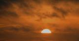 SUN RISING FROM A CLOUD