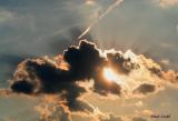 SUN BEHIND THE CLOUDS AT DUSK