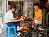 Men Playing Chess With a Self Made Board and Pieces