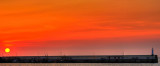 Setting sun over the harbour wall, Peel, Isle of Man