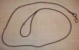 Brown braided bolo leash with a clip