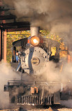 The 203 leaves the small riverseide engine house and heads out to the mainline 