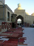 Bukhara - a sea of red carpets lights up an evening stroll