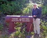  GT standing by old Cascade Crest Trail Marker Log