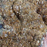Pharmacosiderite crystals to 1 mm on 43 mm matrix. Burdell Gill, Caldbeck Fells, Cumbria, UK.