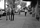 TOURISTS ON HENDERSONVILLES MAIN STREET - CAMERA HELD AT WAIST LEVEL, WHILE WALKING