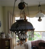 Dining Room chandelier with unconverted oil lamp in bay window