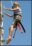 Barefoot boy climbing wall