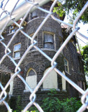 <b>Spring 2009</b> A chain link fence safeguards the house.