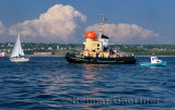 Tourist tugboat and sailboat in Halifax harbour Dartmouth Nova Scotia