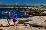 Tourists on the granite rocks of Peggys Cove at St Margarets Bay Nova Scotia