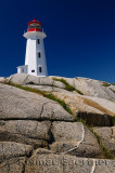 Peggys Cove lighthouse on smooth granite rocks against a blue sky Nova Scotia