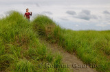 Girl tourist on Port Maitland beach sand dunes with grass Nova Scotia