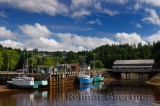 Covered bridge and wharf with boats at low tide in St Martins New Brunswick